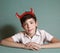 Happy preteen boy in red horns close up portrait