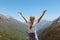 Happy preteen girl hiking on caucasian mountains in summer.