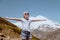 Happy preteen girl hiking on caucasian mountains in summer.