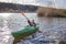 Happy preteen girl kayaking on river, paddle in the hand, summer camp activity, extreme sport