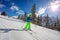 Happy preteen skiing down track in sunny resort