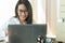 Happy pretty asian business woman entrepreneur smiling and working on the desk in his home. Successful young businesswoman.