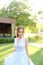 Happy pretty bride standing in garden.