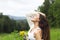 Happy pretty brunette woman in chamomile field