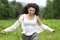 Happy pretty brunette woman in chamomile field, cute female relaxed on flowers meadow