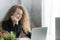 Happy pretty business woman entrepreneur smiling and working on the desk in his home. Successful young businesswoman in e commerce