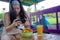 Happy and pretty digital nomad Asian Korean girl taking picture of fruit salad with mobile phone for sharing on internet social me