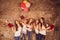 Happy pretty girls holding birthday cake, balloons and presents