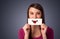 Happy pretty woman holding card with funny smiley