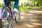 Happy pretty young girl bicycling on summer park. Happy relax time in city. Beautiful woman, sunny day