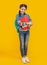 Happy pupil yellow background. Teenage pupil holding books. Pupil back to school