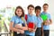 Happy pupils in school uniform with backpacks