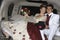 Happy Quinceanera Sitting In Limousine With Partner