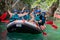 Happy rafting team on the boat with full equipment