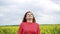 Happy red girl looking on the sky, smiling in the field 4k