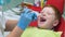 Happy red-haired boy at reception at dentist in dental chair. Medicine, dentistry and healthcare concept. Safe Dentistry