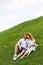 happy redhead couple sitting on grassy