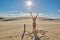 Happy Redhead Lady waving hands against Sunset at Sand Dunes in