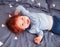 Happy redhead toddler baby having fun in bed