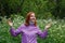 Happy redhead woman with lowered protective mask under her chin and ponytail in the forest. Covid 19 vaccine. Recovery after