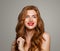 Happy redhead woman smiling. Excited red head girl with curly hairstyle. Ginger hair, cute smile, red lips makeup