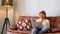 Happy and relaxed cute woman at home use laptop lay down on the sofa at home - alternative and modern people in smart work -