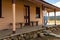 Happy relaxed female on verandah of old timber home in the rural countryside