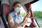 Happy relaxed woman with KN95 FFP2 face mask using smart phone on public transport. Bus passenger with protective mask texting on
