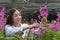 Happy researcher botanical research orchid wearing a white cap and cutting Orchid flower to research in the orchid garden