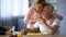 Happy retired couple hugging at home kitchen, love and harmony, cooking leisure