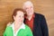 Happy Retired Couple on Wooden Wall Background