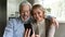 Happy retired family couple using mobile phone for video call