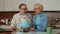 Happy retired senior couple with globe World map planning holiday trip together