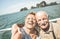 Happy retired senior couple taking travel selfie around world