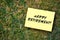 Happy retirement message written on yellow paper on green grass