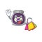 A happy rich grape jam waving and holding Shopping bag