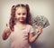 Happy rich kid girl holding money and showing thumb up sign. Vin