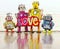 Happy robot family with a bright color cloth love sign