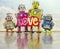 Happy robot family with a bright color cloth love sign