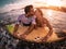 Happy romantic couple kissing while surfing in the ocean - Sporty surfers bodybording having a tender moment in the water