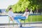 Happy romantic couple in Paris, sitting on traditional green metal chairs in Tuileries garden