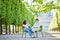 Happy romantic couple in Paris, sitting on traditional green metal chairs in Tuileries garden