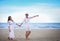 Happy Romantic Couples lover holding hands together walking on the beach