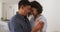 Happy romantic hispanic couple embracing and dancing in living room