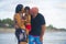 Happy and romantic mixed ethnicity couple Caucasian man and Asian Indonesian woman kissing their little son, the parents holding