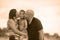 Happy and romantic mixed ethnicity couple Caucasian man and Asian Indonesian woman kissing their little son, the parents holding