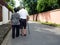 Happy romantic senior asian couple walking and holding hands on the road at the village. Concept of senior couple and take care