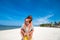 Happy romantic young couple on a beautiful beach with white sand. Caucasian couple having vacation on the tropical