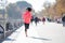 Happy runner woman in Autumn or Winter sportswear running and tr