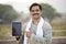 Happy rural Indian farmer showing digital tablet screen